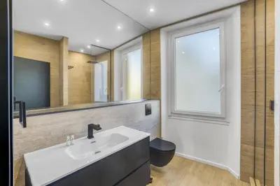 a bathroom with a white sink and a window at 3 chambres Modern - 2 min du Palais - Climatisé - Calme in Cannes