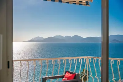 a view of the ocean from a balcony at Wonderful 2 bedroom apartment with sea view in Cannes