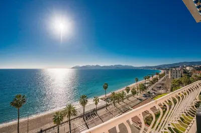 a view of the beach and the ocean from a balcony at Wonderful 2 bedroom apartment with sea view in Cannes