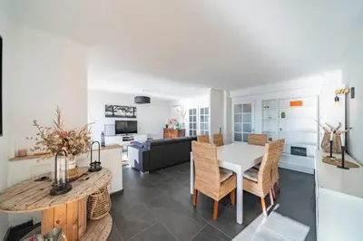 a kitchen and living room with a table and chairs at Wonderful 2 bedroom apartment with sea view in Cannes