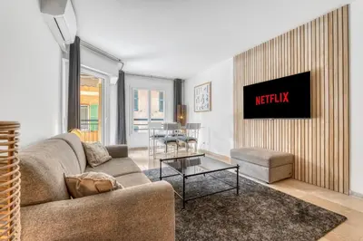 a living room with a couch and a table at 1 Chambre - Ascenseur - Spacieux - Proche palais in Cannes