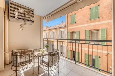 a balcony with two chairs and a view of buildings at 1 Chambre - Ascenseur - Spacieux - Proche palais in Cannes