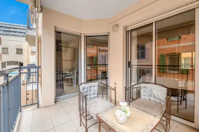 a balcony with two chairs and a table at 1 Chambre - Ascenseur - Spacieux - Proche palais in Cannes