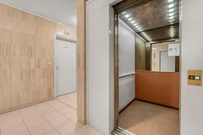 a hallway with a door leading into a room at 1 Chambre - Ascenseur - Spacieux - Proche palais in Cannes