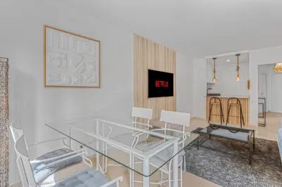 a glass table and chairs in a living room at 1 Chambre - Ascenseur - Spacieux - Proche palais in Cannes