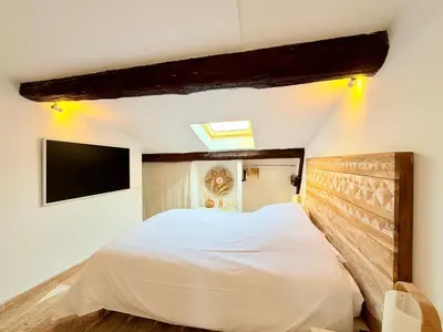 a bedroom with a bed and a tv on the wall at Charmant Appartement à 50m du Palais des Festivals et de la Croisette in Cannes