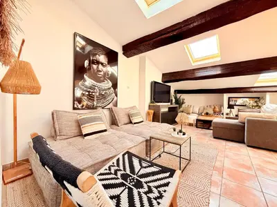 a living room with a couch and a table at Charmant Appartement à 50m du Palais des Festivals et de la Croisette in Cannes