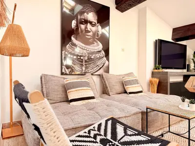 a living room with a couch and a picture of a woman at Charmant Appartement à 50m du Palais des Festivals et de la Croisette in Cannes