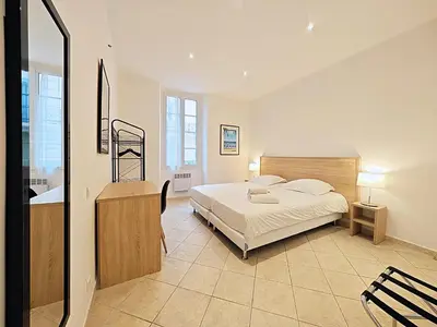 a bedroom with a bed and a sink in it at Viva Riviera 11 rue Commandant André in Cannes