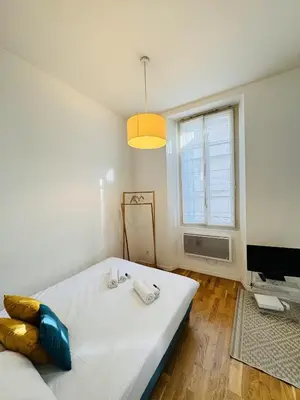 a bedroom with a large white bed and a window at Studio chaleureux proche croisette Mimont29 in Cannes