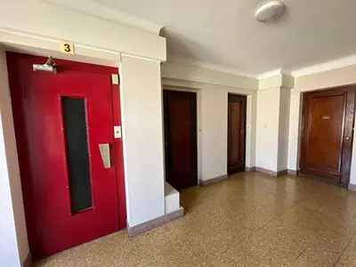 a red door in a room with three doors at A003-Magnifique appartement proche du centre de Cannes in Cannes