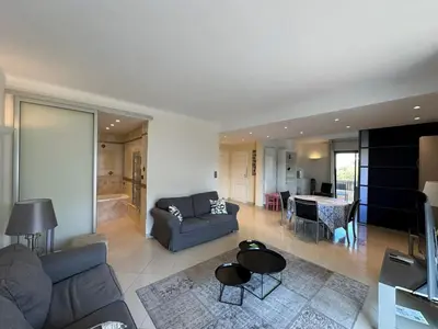 a living room with a couch and a table at A003-Magnifique appartement proche du centre de Cannes in Cannes