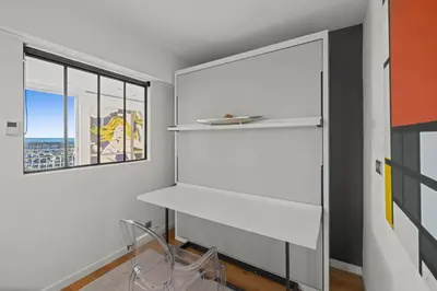 a room with white shelves and a window at REF 1926 - Cannes Center - Sea view apartment for rent in Cannes