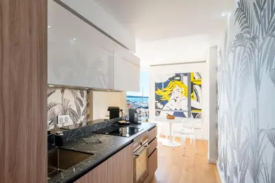 a kitchen with a black counter top in a room at REF 1926 - Cannes Center - Sea view apartment for rent in Cannes