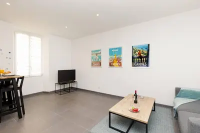 a living room with a couch and a table at Vagliano Standing Presta in Cannes