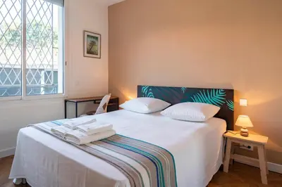 a bedroom with a white bed with towels on it at Cozystay 1331 - 4-bedroom apartment La Croisette in Cannes