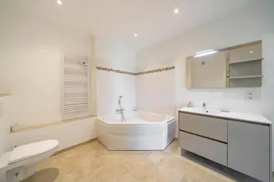 a white bathroom with a toilet and a sink at Cozystay 1331 - 4-bedroom apartment La Croisette in Cannes