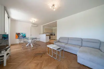 a living room with a couch and a table at Cozystay 1331 - 4-bedroom apartment La Croisette in Cannes