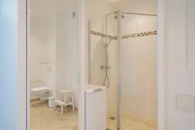a bathroom with a shower and a toilet at Cozystay 1331 - 4-bedroom apartment La Croisette in Cannes