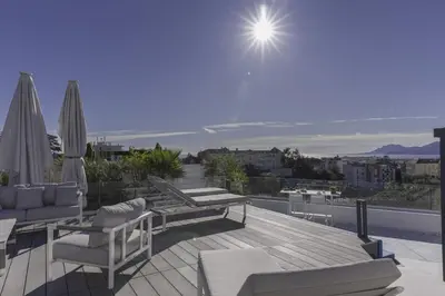 a rooftop deck with a view of the ocean at Luxury Penthouse Montfleury by Halldis in Cannes