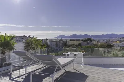 a pair of chairs and a table on a balcony at Luxury Penthouse Montfleury by Halldis in Cannes