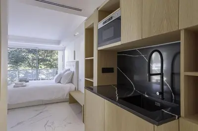 a bedroom with a bed and a kitchen with a sink at Luxury Penthouse Montfleury by Halldis in Cannes
