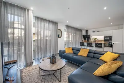 a living room with a blue couch and a table at C035-Cannes Centre appartement 3 pièces avec parking in Cannes