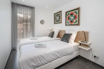 a bedroom with two beds and a window at C035-Cannes Centre appartement 3 pièces avec parking in Cannes