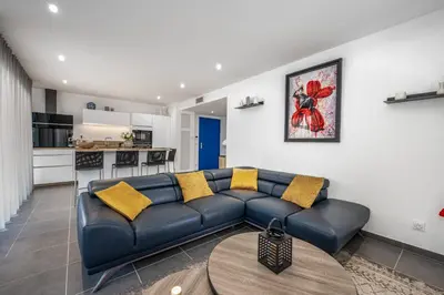 a living room with a blue couch and a kitchen at C035-Cannes Centre appartement 3 pièces avec parking in Cannes