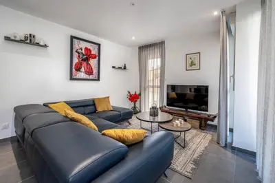 a living room with a blue couch and a tv at C035-Cannes Centre appartement 3 pièces avec parking in Cannes
