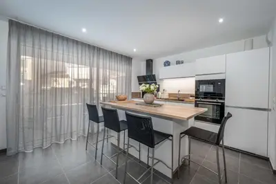 a kitchen with a table and some chairs at C035-Cannes Centre appartement 3 pièces avec parking in Cannes