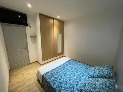 a small bedroom with a bed and a door at Holiday Home l'Angelet in Vallauris