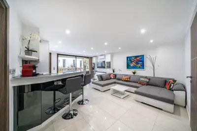 a living room with a couch and a bar at Wonderful 2 bedroom apartment in Cannes