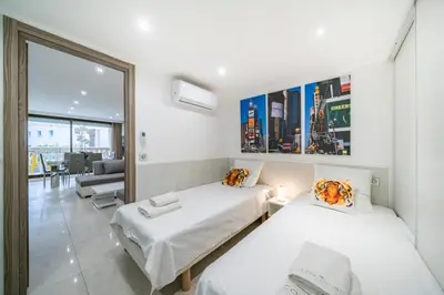 a bedroom with two beds and a living room at Wonderful 2 bedroom apartment in Cannes