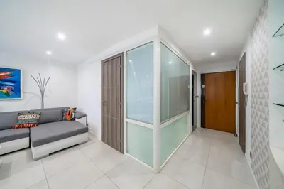 a living room with a couch and a glass door at Wonderful 2 bedroom apartment in Cannes