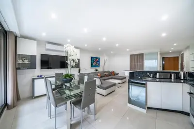 a kitchen and living room with a table and a couch at Wonderful 2 bedroom apartment in Cannes