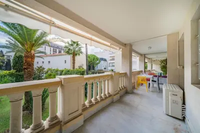 a balcony with a view of a palm tree at Wonderful 2 bedroom apartment in Cannes