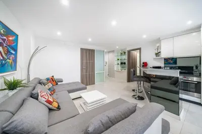 a living room with a couch and a kitchen at Wonderful 2 bedroom apartment in Cannes