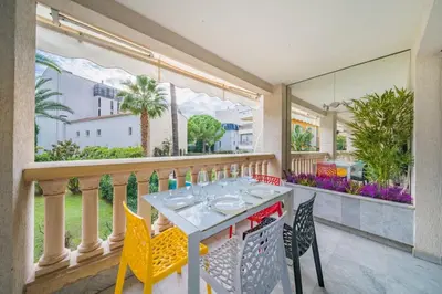 a dining room with a table and chairs on a balcony at Wonderful 2 bedroom apartment in Cannes