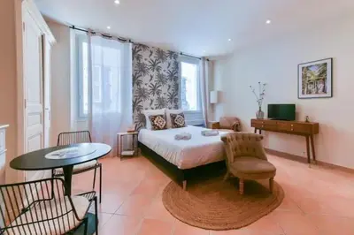 a bedroom with a bed and a table and chairs at B062-Studio palais des festivals in Cannes