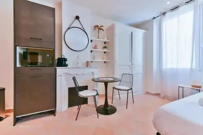 a bedroom with a bed and a table and chairs at B062-Studio palais des festivals in Cannes
