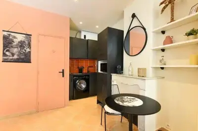 a kitchen with a table and a black and pink door at B062-Studio palais des festivals in Cannes