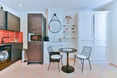 a kitchen with a table and chairs in a room at B062-Studio palais des festivals in Cannes