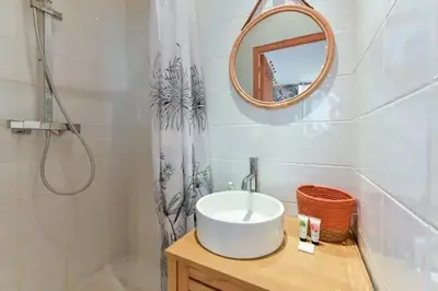 a bathroom with a sink and a mirror and a shower at B062-Studio palais des festivals in Cannes