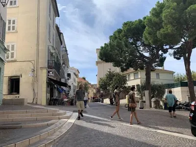 a group of people walking down a street at C098- Cannes - Suquet Bel appart - Grande Terrasse in Cannes