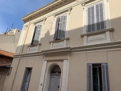 a large white building with a door and windows at C098- Cannes - Suquet Bel appart - Grande Terrasse in Cannes
