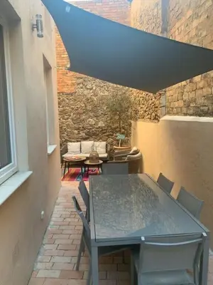 a table and chairs on a patio with a stone wall at C098- Cannes - Suquet Bel appart - Grande Terrasse in Cannes