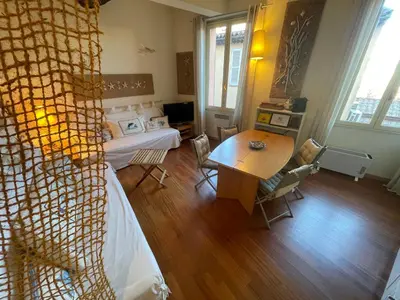 a bedroom with a bed and a table and a desk at Le Suquet Style IV by Connexion in Cannes