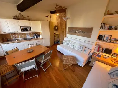 a bedroom with a bed and a table and chairs at Le Suquet Style IV by Connexion in Cannes