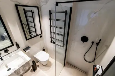 a bathroom with a toilet and a glass shower at The RoofTop by Connexion in Cannes